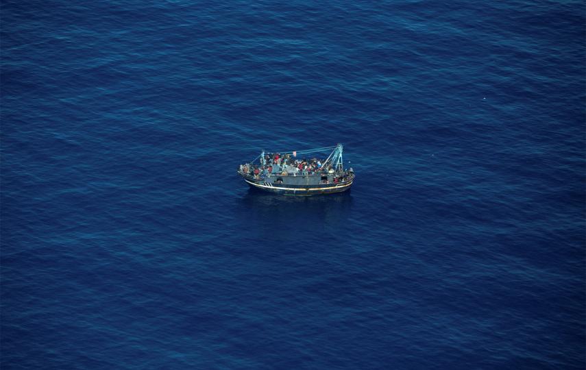 An aerial view of a boat at see with around 400 migrants traveling from North Africa into Europe.