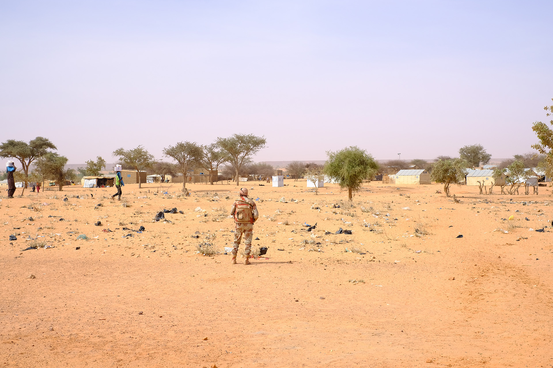 A soldier stands guard outside a site for refugees and internally displaced people in Niger’s Tillabéri region in April. Displacement has soared in recent months as violence rises.