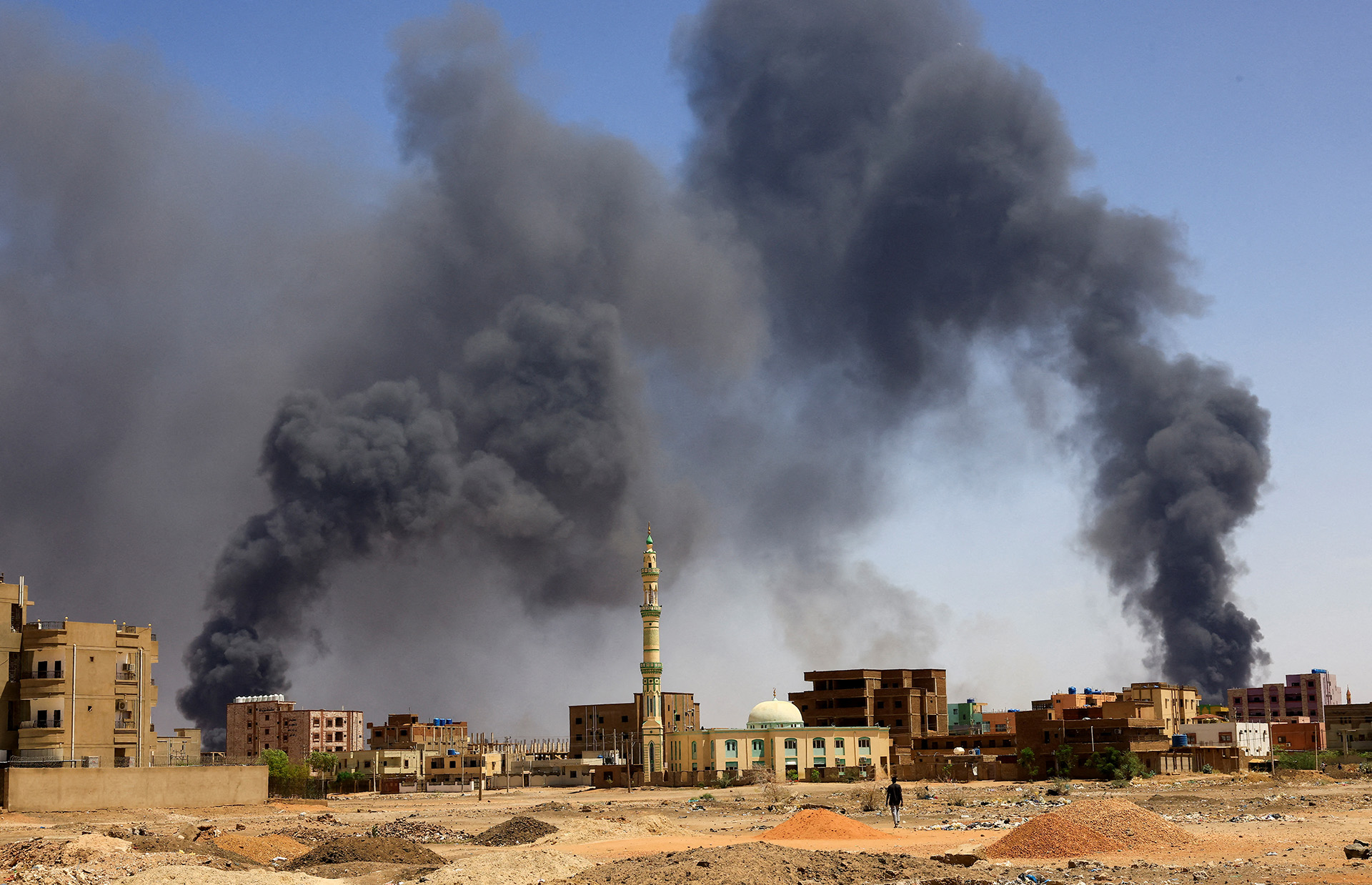 A photo of dark smoke plumes rising over Khartoum